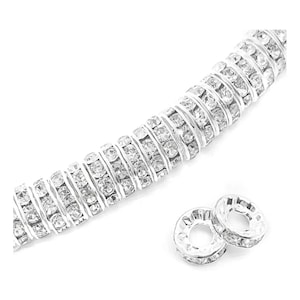 May include: Silver-toned, round, crystal-encrusted beads. The beads are strung together to form a chain. Two individual beads are shown separately.