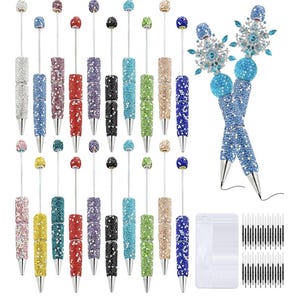 May include: A selection of decorative pens, each covered in colourful rhinestones. The pens come in a variety of colours, such as silver, pink, red, purple, black, green, and blue. Each pen has a matching rhinestone ball at the top and includes ink refills.