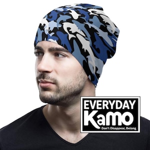 May include: A blue, white, and black camouflage beanie. The beanie is made of a soft material and is designed to fit snugly. The text "EVERYDAY Kamo" is displayed in a black and white rectangle, with the tagline "Don't Disappear, Belong."