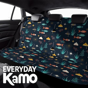 May include: A dark blue car seat cover featuring a repeating pattern of orange and teal fish, stylized hanging pendant lamps, green seaweed, and starburst shapes. The text "EVERYDAY Kamo" is printed in white in the lower left corner of the image.