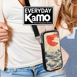 May include: Black crossbody phone bag with a zipper closure and a strap. The bag features a Japanese-style print of a red sun over ocean waves. The text "EVERYDAY Kamo" is displayed in a black and white rectangle.