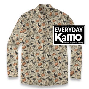 May include: A long-sleeve button-down shirt featuring a repeating pattern of postage stamp-style illustrations of black cats, orange pumpkins, and bats on a beige background. A rectangular logo reads EVERYDAY Kamo Don't Disappear, Belong.