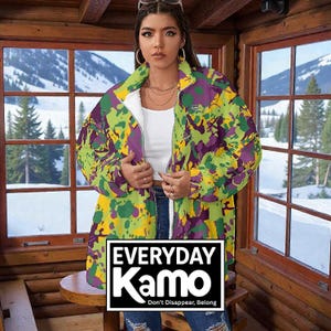 May include: A long, zip-up jacket with a vibrant camouflage pattern in shades of green, yellow, and purple. The jacket has a white interior lining and features the text "EVERYDAY Kamo" in a black and white box. The text "Don't Disappear, Belong" is below the logo.