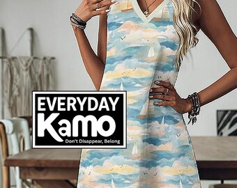 May include: A sleeveless dress with a V-neckline, featuring a nautical pattern of sailboats, clouds, and birds in shades of blue, yellow, and white. The dress has the text "EVERYDAY Kamo" in a black and white box, with the tagline "Don't Disappear, Belong."