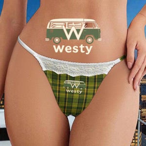 May include: A green and yellow plaid thong with a white lace trim. The thong features a graphic of a green and white van with the word "westy" in white. The same graphic is repeated on the waistband.