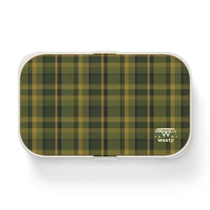 May include: A white lunchbox with a green and yellow plaid pattern and a small white VW van logo with the text "Westy".