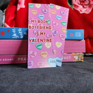 May include: Pink and white bookmark with a heart design and the text "My Book Boyfriend is My Valentine".