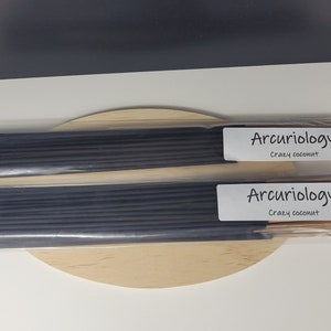 May include: Two packs of black incense sticks with white labels that read "Arcuriology" and "Srazy coconut".