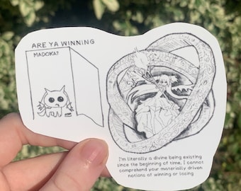 May include: Black and white sticker with a cartoon character and text that reads "ARE YA WINNING MADOKA?" and "I'm literally a divine being existing since the beginning of time, I cannot comprehend your materially driven notions of winning or losing."