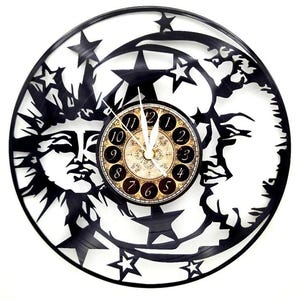 May include: A black celestial-themed wall clock featuring a sun, moon, and stars design. The clock face has a vintage style with Roman numerals. The clock is made from a recycled vinyl record.