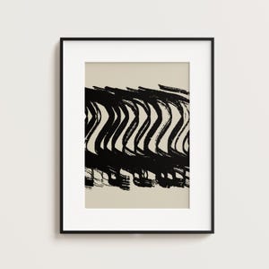 May include: A white ceramic mug with a black handle and the text "But First, Coffee" in a black, bold font. The mug is on a white surface.