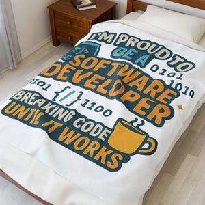 May include: White blanket with the text "I'M PROUD TO BE A SOFTWARE DEVELOPER" in teal and orange. The blanket also features binary code, curly brackets, and a coffee cup graphic. A perfect gift for a software developer.