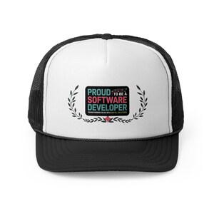 May include: A black and white trucker hat with a white front panel. The hat features the text "PROUD TO BE A SOFTWARE DEVELOPER" in teal and pink, surrounded by a laurel wreath design. The hat's brim is black.