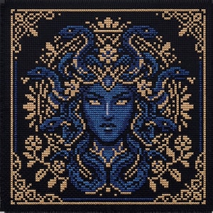 May include: A square cross-stitch embroidery on black fabric featuring a central face with blue skin and golden eyes. The figure is surrounded by blue snakes and intricate golden floral patterns, all enclosed within a decorative golden border.
