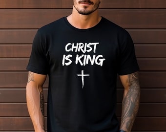 May include: Black t-shirt with white text that reads "CHRIST IS KING" and a white cross.