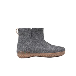 Charcoal gray handmade outdoor boots with durable rubber soles, rugged stitching, and ankle-high design, ideal for hiking and everyday wear.