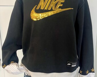 Black sweatshirt with gold logo and renewed sleeves with matching gold stars