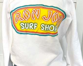 Upcycled sweatshirt with surf shop logo