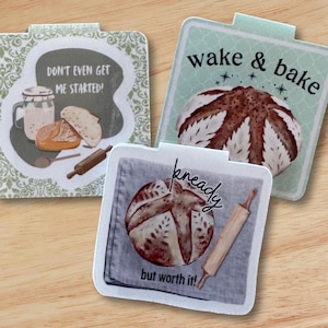 May include: Three decorative tags with watercolor illustrations of bread and baking tools. One tag reads "Don't even get me started!" with a jar, bread, and rolling pin. Another says "wake & bake" with a loaf of bread. The third says "kready but worth it!" with bread and a rolling pin.
