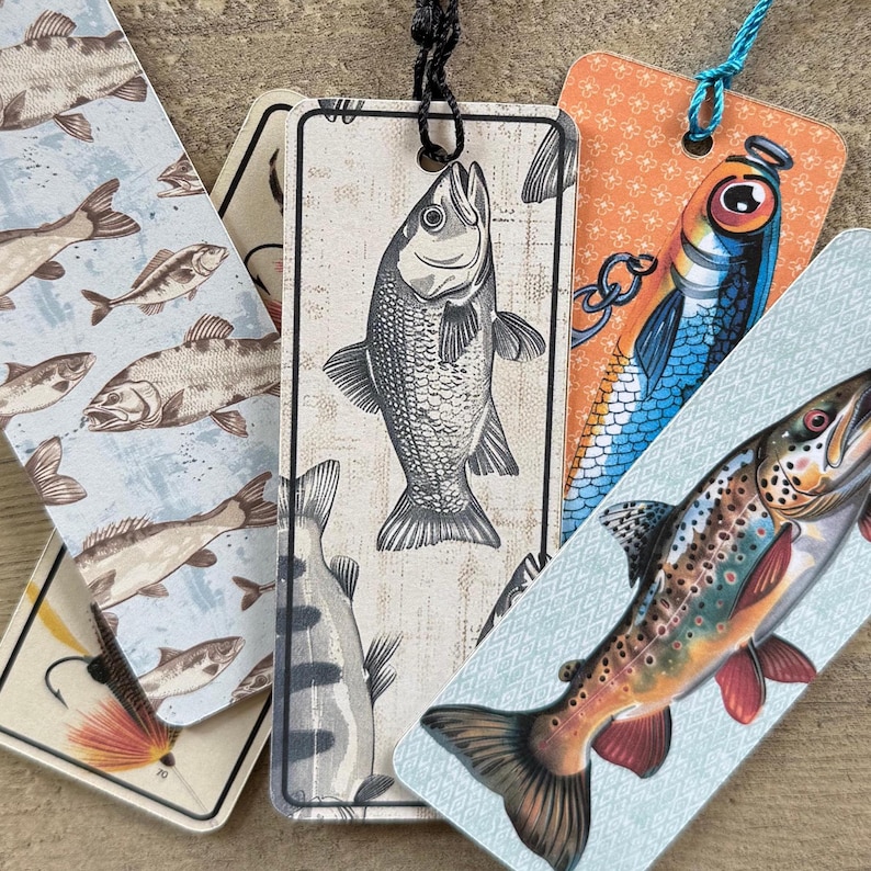 May include: Five different bookmark designs featuring various fish illustrations. The bookmarks are printed on cardstock and have a blue, white, and orange color scheme. The bookmarks are perfect for book lovers and anglers.