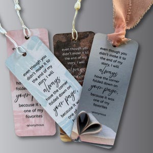 May include: Four rectangular bookmarks with quotes and attached strings. The bookmarks are in shades of pink, blue, brown, and gray. Each bookmark has a quote about books and reading. The text includes the word "always".