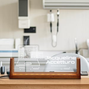May include: A clear acrylic desk nameplate with a wooden base. The nameplate features a laptop and phone graphic with programming language icons. The name "Jacqueline Accetturo" and "Software Engineer" are displayed in white text.