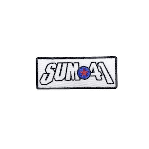 May include: A rectangular patch with the text "SUM 41" in white, outlined in black. The "O" in "SUM" is replaced with a blue circle containing a red star. The patch has a black border and is set against a white background.