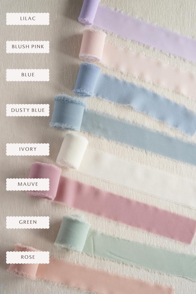 May include: Seven spools of frayed-edge ribbon in various colours, labelled as Lilac, Blush Pink, Blue, Dusty Blue, Ivory, Mauve, Green, and Rose. Each spool is rolled with a textured fabric finish, displaying a soft, matte appearance.