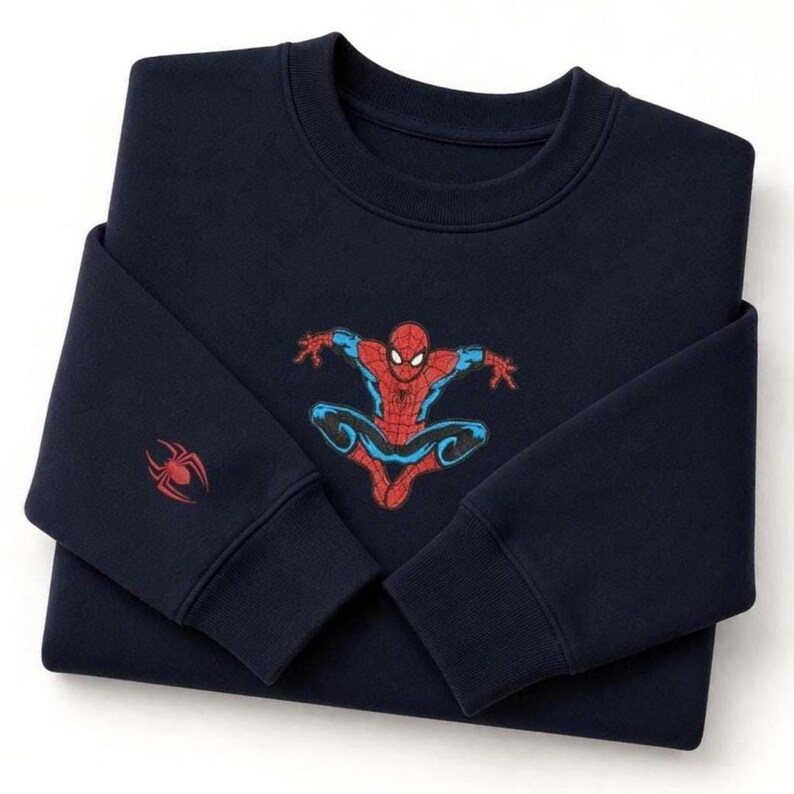 May include: Navy blue sweatshirt featuring a Spider-Man graphic in red, blue, and black. The superhero is depicted in a dynamic pose. A red spider emblem is on the left sleeve. This crewneck sweatshirt is a great gift for fans of the Marvel comic book character.