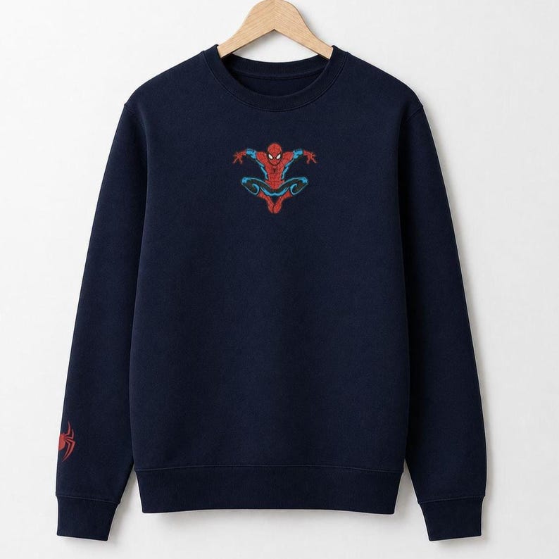 May include: Navy blue sweatshirt featuring a colorful Spider-Man graphic on the chest. The long-sleeved crewneck also has a Spider-Man logo on the left sleeve. The sweatshirt is made of a soft material and is suitable for casual wear.