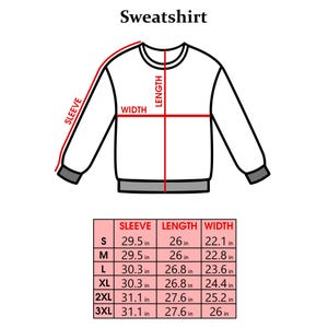 May include: A white sweatshirt with a diagram showing sleeve, length, and width measurements. The text "Sweatshirt" is at the top. A size chart below shows measurements in inches for sizes S, M, L, XL, 2XL, and 3XL.