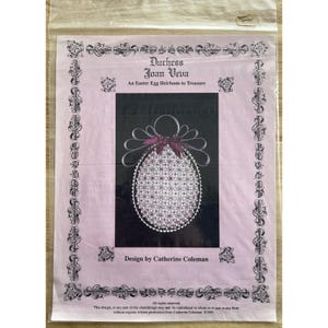 May include: A package featuring a cross-stitch pattern for an Easter egg heirloom. The design, by Catherine Coleman, includes the text "Duchess Joan Veiva" and "An Easter Egg Heirloom to Treasure." The egg design is white with a purple ribbon.