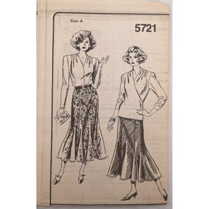 May include: Vintage sewing pattern with two illustrations of women's outfits. One woman is wearing a long patterned skirt, a blouse, and a belt. The other is wearing a wrap top and a long skirt. The pattern number is 5721.