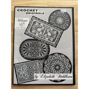 May include: A vintage crochet pattern book titled "CROCHET ORIGINALS Volume 12" featuring various black and white crochet doily designs. The cover includes the text "by Elizabeth Hiddleson" and "Printed in the U.S.A."