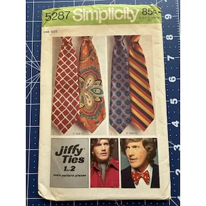 May include: Vintage Simplicity sewing pattern for Jiffy Ties, featuring four tie designs. The pattern includes a red geometric tie, an orange paisley tie, a blue patterned tie, and a striped tie. The pattern is marked "One Size".