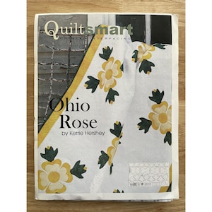 May include: A printed interfacing pattern for a quilt, featuring the text "Quiltsmart" and "Ohio Rose by Kerrie Hershey." The quilt design includes yellow and white flowers with green leaves on a white background.