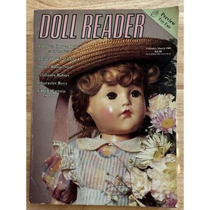 May include: A vintage "DOLL READER" magazine cover featuring a doll wearing a straw hat and holding flowers. The magazine's title is in pink, with additional text including "February/March 1958" and "Preview Toy Fair."