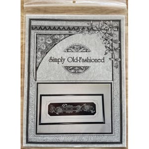 May include: A craft kit in a clear plastic bag. The kit features a black and white floral design with the text "Simply Old-Fashioned." The design is framed with a black border and includes a detailed floral pattern.