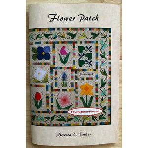 May include: A booklet titled "Flower Patch" featuring a colorful quilt design with various flower patterns. The quilt design includes squares with blue, pink, white, and yellow flowers, and the text "Foundation-Pieced". The author's name, Marcia L. Baker, is also visible.