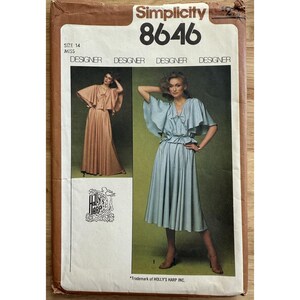 May include: Simplicity 8646 sewing pattern featuring a designer dress. The pattern includes a size 14. The cover shows two women modeling the dress in different colors. The text "Designer" is repeated multiple times.