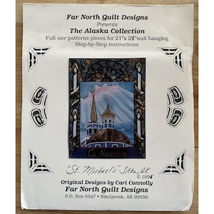 May include: A paper pattern for a quilt featuring a church with gold domes and a blue sky. The text reads "The Alaska Collection" and "St. Michael's Sitka, AK". Includes step-by-step instructions for a 21" x 27" wall hanging.
