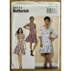 May include: A Butterick sewing pattern, B6514, featuring illustrations of three different dresses. The dresses have varying sleeve lengths and skirt styles. The pattern includes sizes 6-8-10-12-14. The cover is white with black text and illustrations.