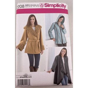 May include: Simplicity pattern 2208 features three coat designs. The pattern includes a tan coat with a decorative collar and cuffs, a blue hooded coat with black polka dots, and a gray wrap coat with decorative trim.