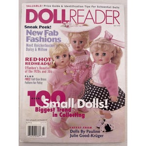 May include: A July 1999 issue of Doll Reader magazine featuring three dolls. The cover includes text such as "New Fab Fashions," "Red-Hot Redheads," and "100 Small Dolls!" The dolls are dressed in pink and white outfits.