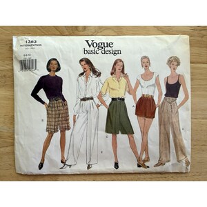 May include: Vogue Basic Design sewing pattern 1383 featuring illustrations of women's clothing designs. The pattern includes designs for shorts, pants, and tops. The cover is white with black text and illustrations.