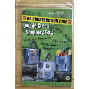 May include: A sewing pattern package for a "Double Green Shopping Bag" made from recycled denim. The package features images of the finished bags, showcasing their design and pockets. Text includes "Re-Construction Zone" and "Easy to Sew!"