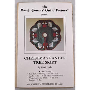 May include: A printed pattern for a Christmas Gander tree skirt. The design features a green skirt with white geese and red heart accents. The text reads "Christmas Gander Tree Skirt" by Carol Hollis.