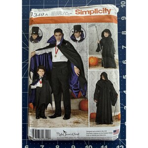 May include: Simplicity sewing pattern 1349A for Halloween costumes. The pattern includes designs for a vampire cape, a hooded cloak, and a grim reaper costume. The package features images of the costumes and the Ruby Jean's Closet logo.