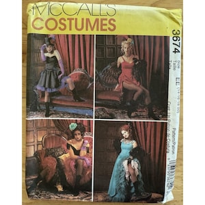 May include: A vintage McCall's Costumes sewing pattern envelope. The envelope features four images of women in theatrical costumes. The text "McCall's Costumes" is printed in large yellow letters at the top.
