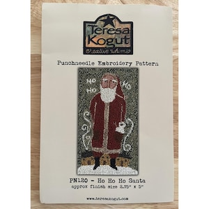May include: A punchneedle embroidery pattern featuring Santa Claus, with the text "Ho Ho Ho." The pattern is by Teresa Kogut, and the finished size is approximately 2.75" x 5". The design includes a red coat, white beard, and a cup.